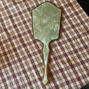 Vintage art deco pearlized green celluloid, and amber colored hand mirror.